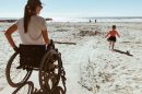 Woman and Child On Wheelchair Accessible Beach