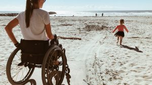 Woman and Child On Wheelchair Accessible Beach