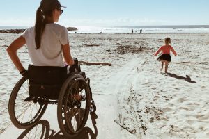 Woman and Child On Wheelchair Accessible Beach