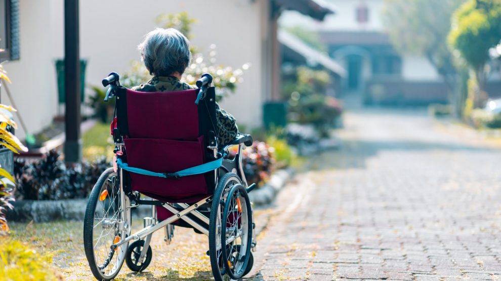 A woman in a wheelchair from the back